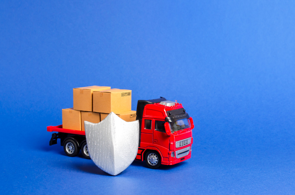 Toy truck with cardboard boxes and shield on blue background.