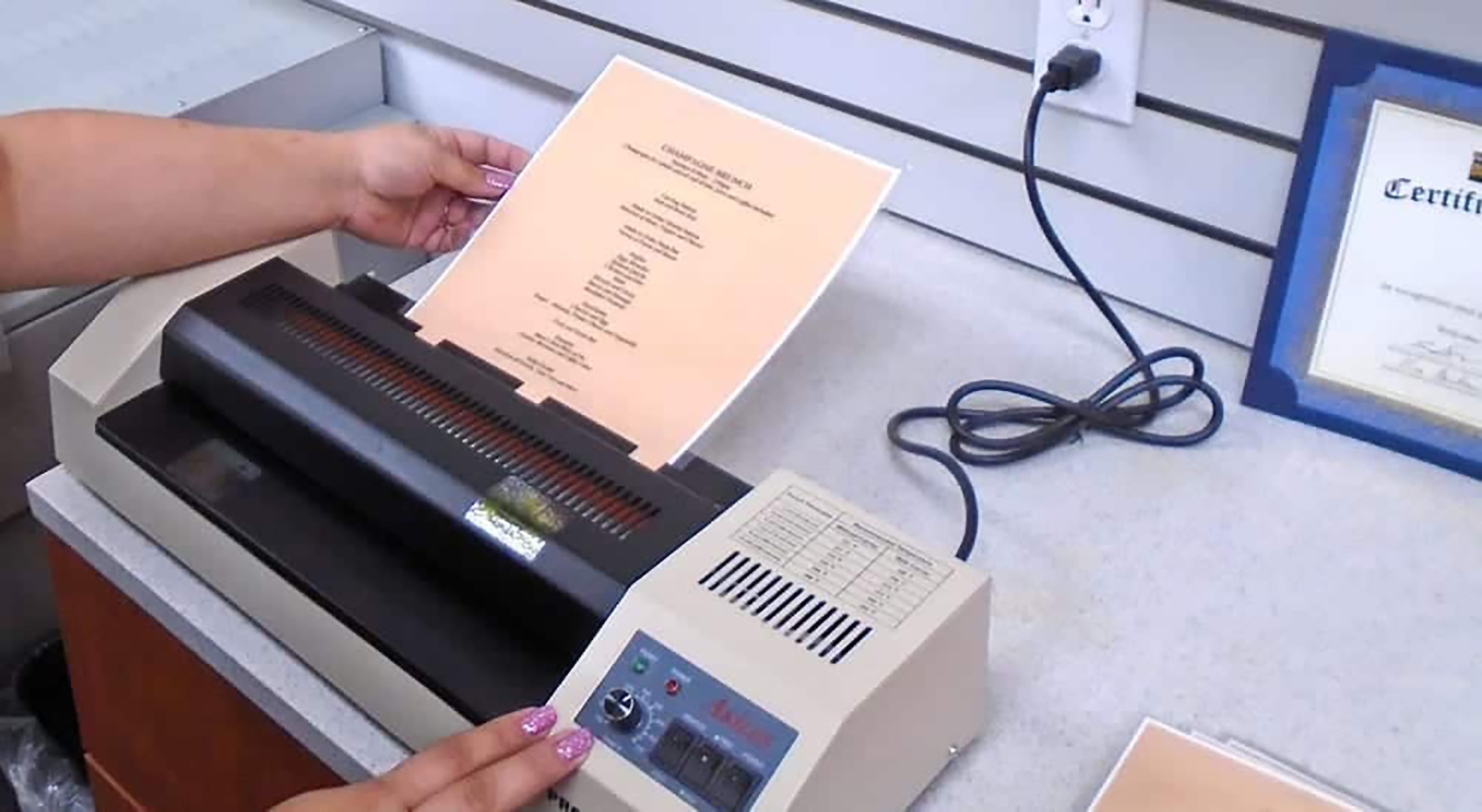 a girl laminating a document