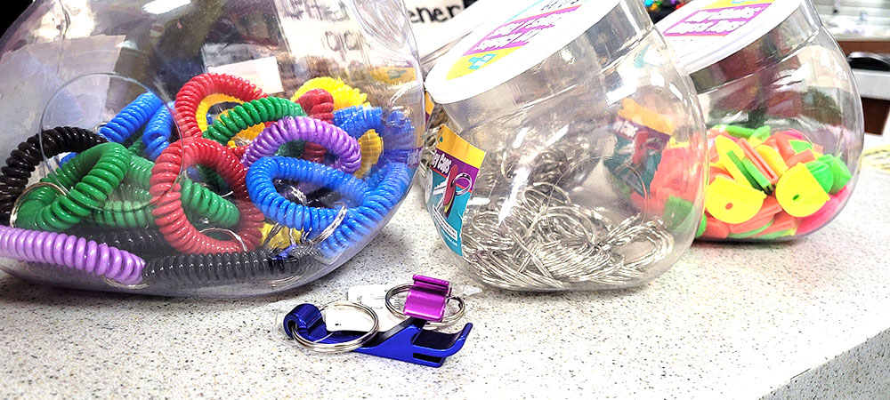 Colorful hair ties and office supplies on desk.