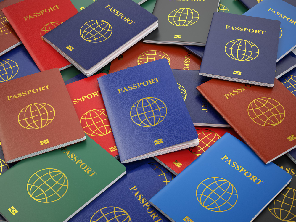 Assorted colorful travel passports spread out.