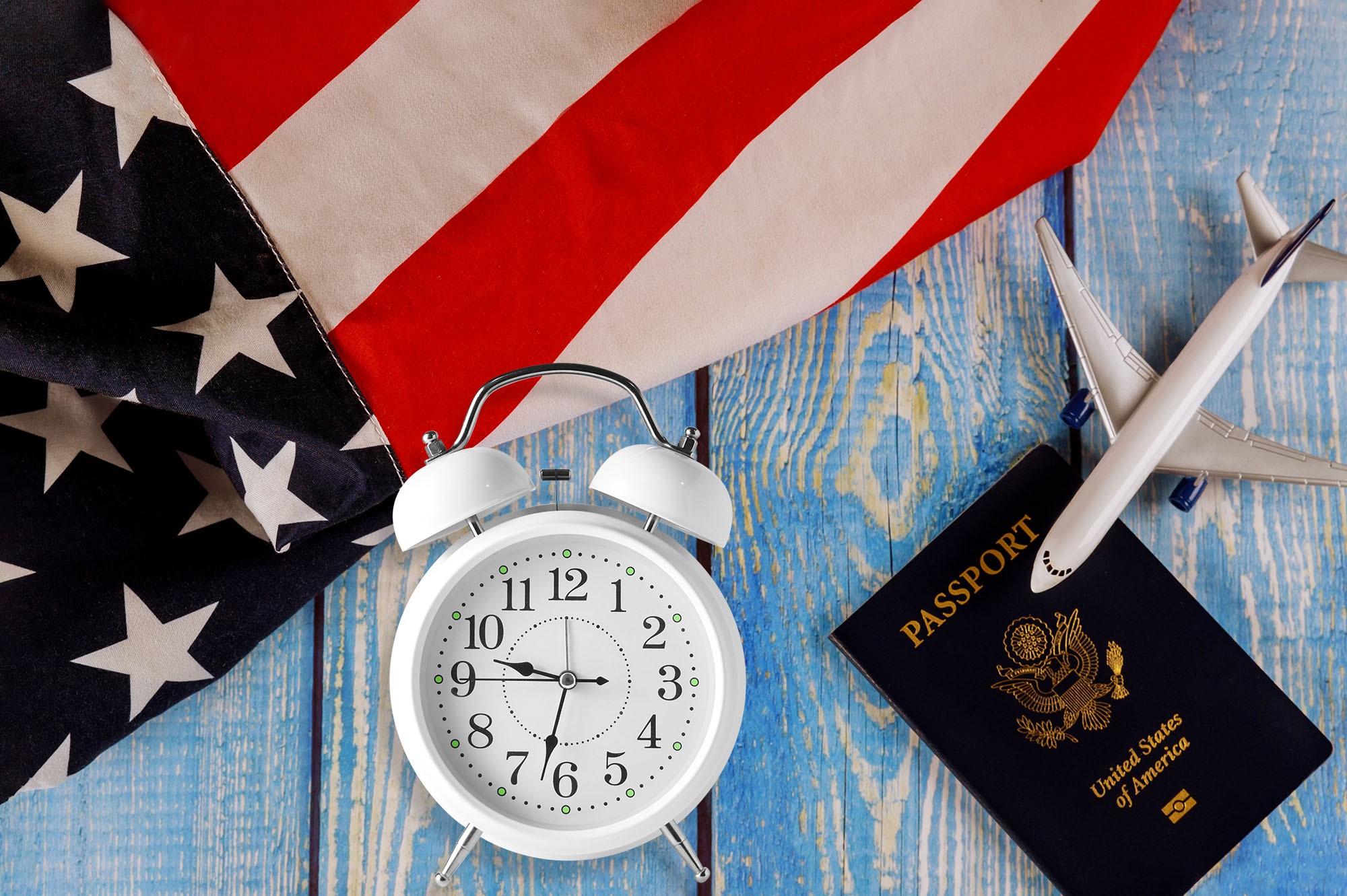 Travel tourism, emigration the USA American flag with U.S. passport and passenger model plane airplane