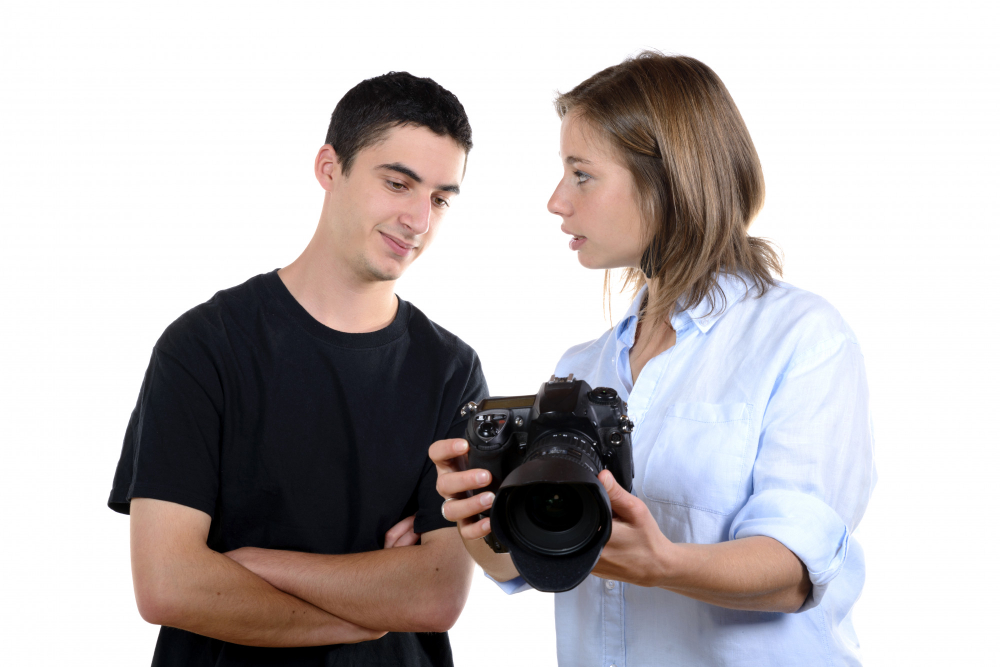 a photographer showing a picture to a subject person